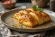 Stromboli med trappistost servert, rik på trappistost på toppen, sprø utenpå og myk inni.